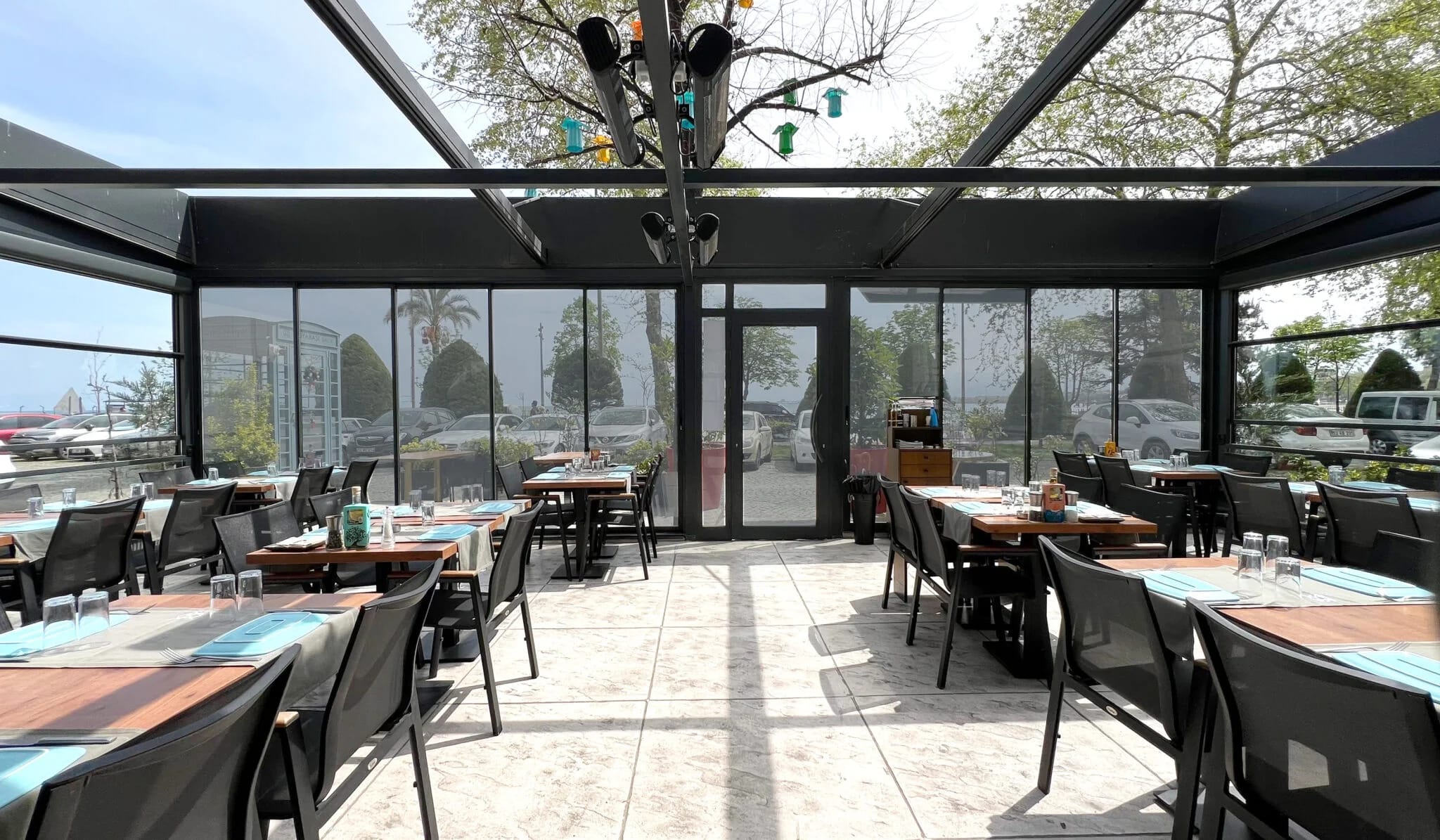 Tabyabasi Balik fish restaurant — glass-enclosed waterfront hospitality architecture with retractable roof