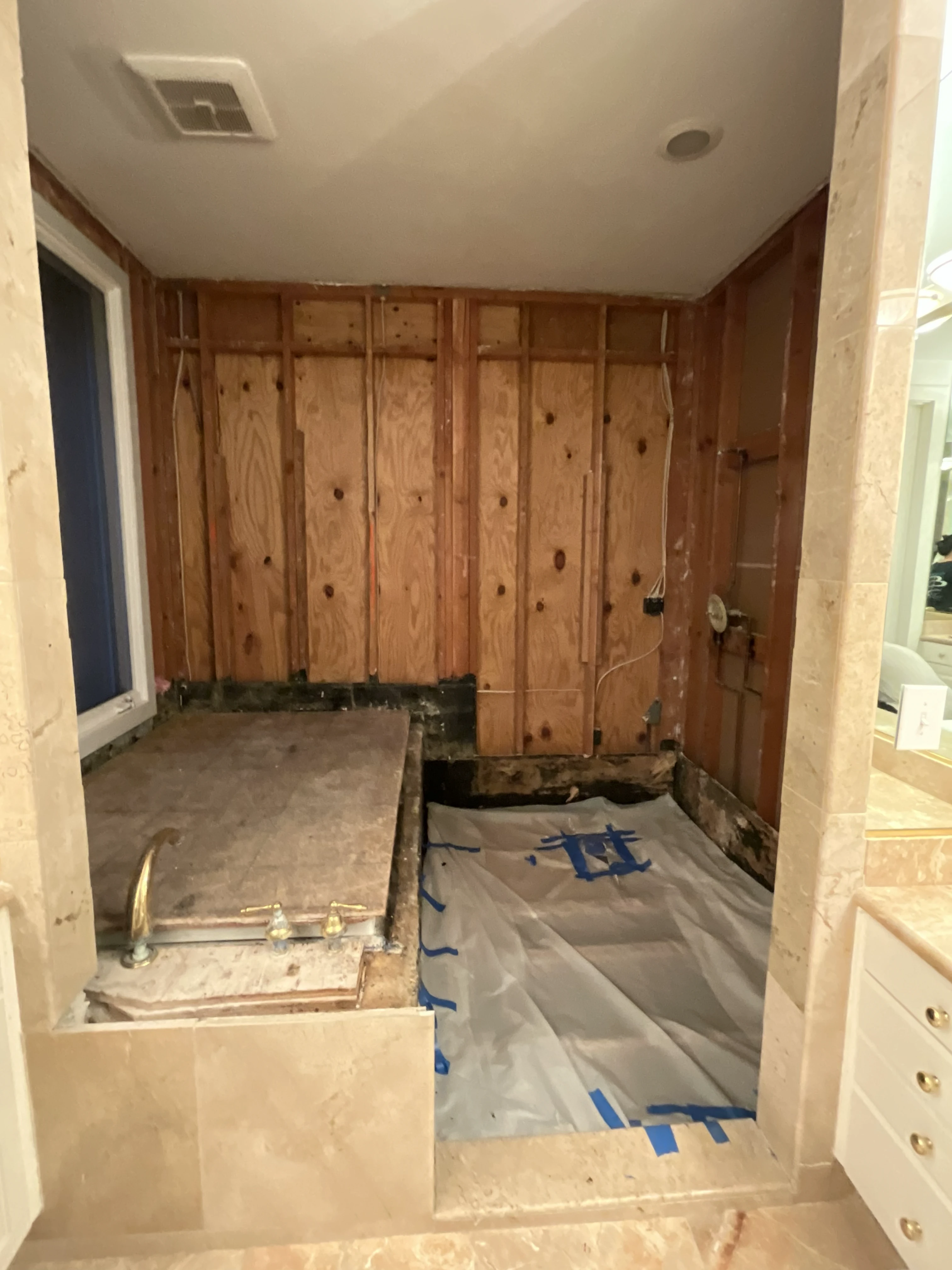 Los Altos Hills bathroom remodel — demolition phase, walls stripped to studs
